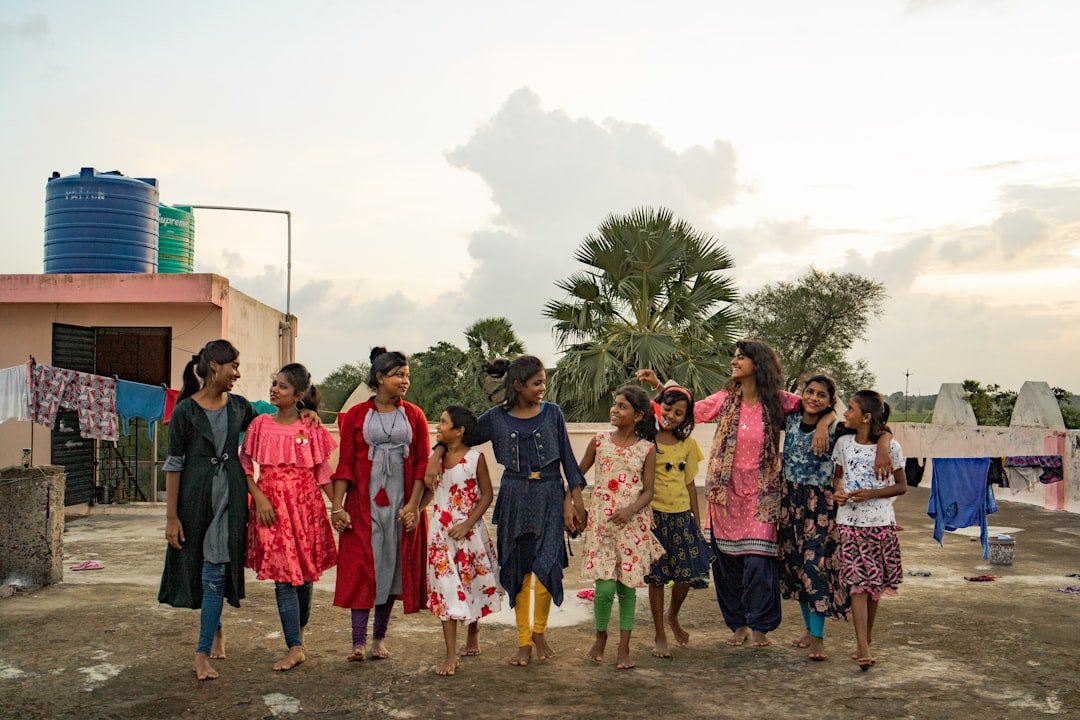 a-group-of-women-standing-next-to-each-other-su668xgmk30